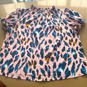 Pastel pink animal print blouse with short puff sleeves.